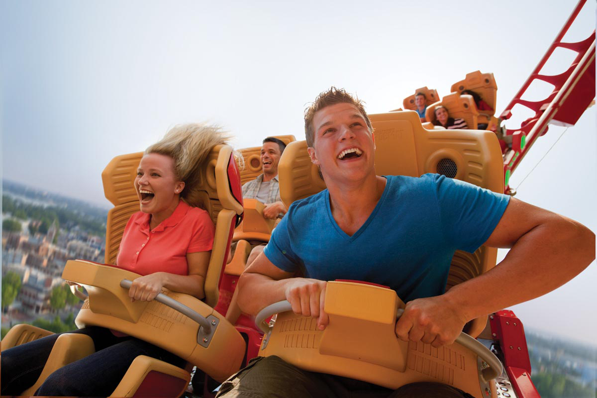 A man and woman enjoying a roller coaster ride at Universal Studios Florida