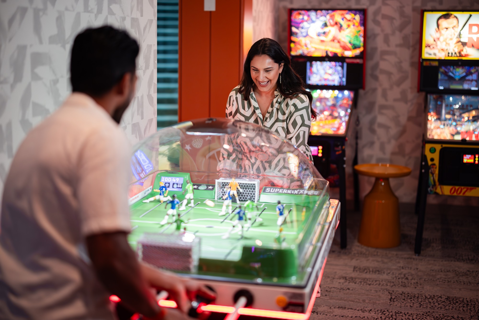 couple playing table soccer