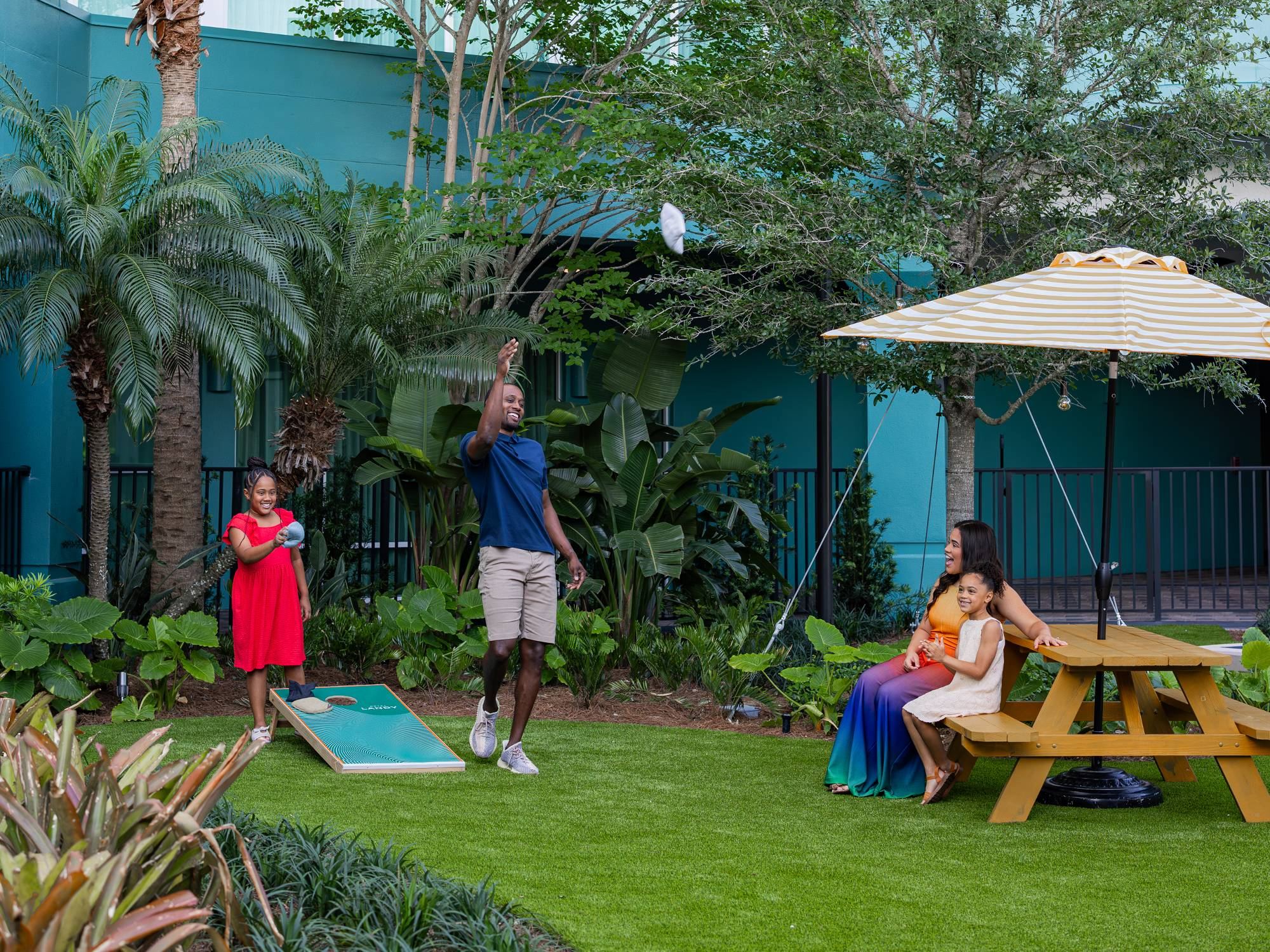 a family playing cornhole