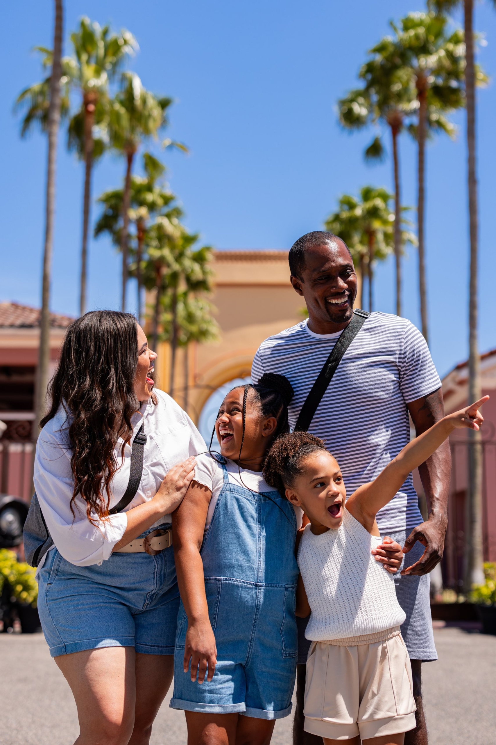 a family standing in front of the Universal Orlando archway